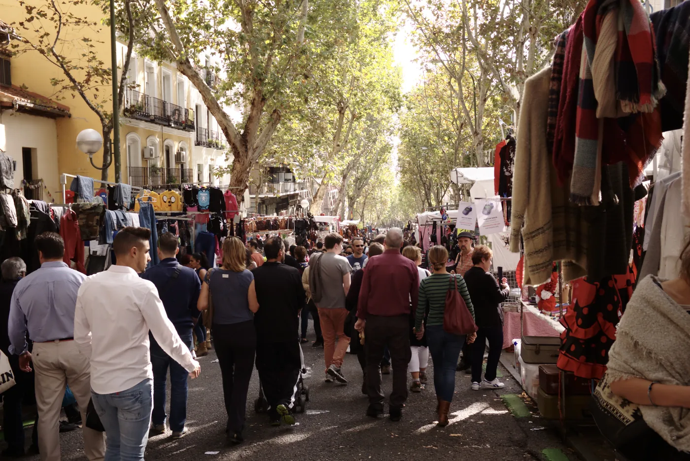 El Rastro market in Madrid with people walking through the street